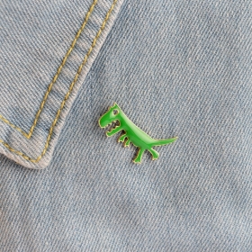 Значок в виде зеленого цвета плотоядного динозавра