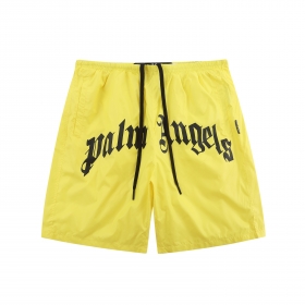 Желтые пляжные шорты Palm Angels с черной надписью бренда спереди