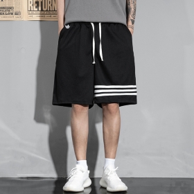 Комфортные шорты от бренда Adidas в черном цвете с белыми полосками