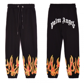 Черные штаны с принтом "Пламя" снизу от бренда Palm Angels
