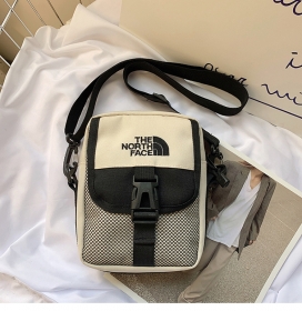 Бежевая сумка-барсетка бренда The North Face с отделкой сеткой