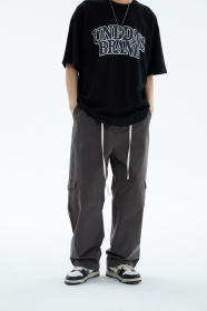 Серые хлопковые штаны от бренда UNINHIBITEDNESS с карманами