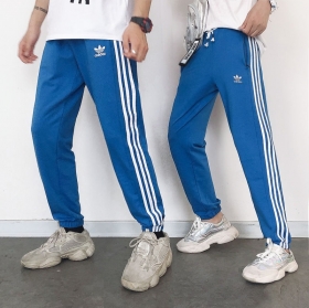 Унисекс синие Adidas с полосками по бокам спортивные штаны