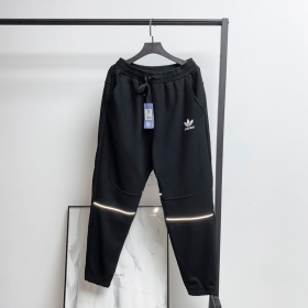 Adidas черного цвета штаны на резинке с карманами на молнии
