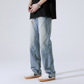 Синие с косыми швами и потёками краски джинсы от бренда Locketomy