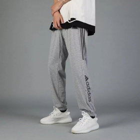 Спортивные трикотажные серого цвета штаны Adidas с логотипом сбоку
